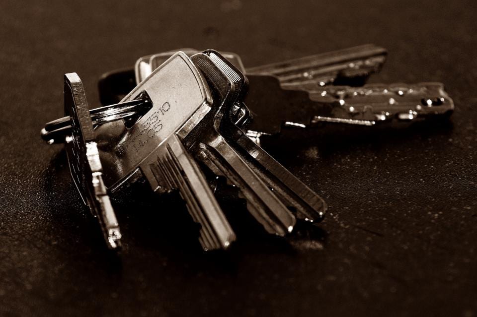 A bunch of house keys on a table